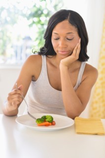 Woman eating vegetables.