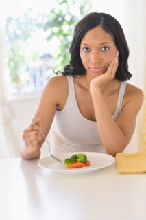 Woman eating vegetables.