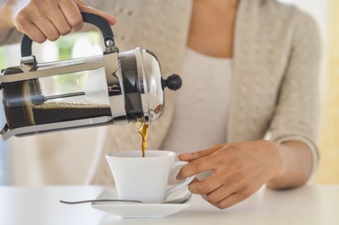 Woman pouring coffee.