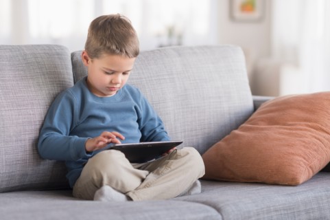 Boy (4-5) using tablet pc.