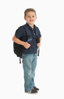Portrait of schoolboy (4-5) carrying backpack.