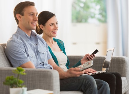 Couple watching tv together.