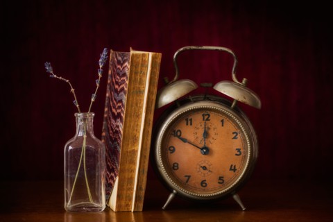 Still life with antique clock and books.