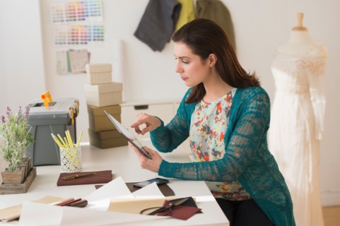 Fashion designer using digital tablet.