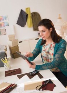 Fashion designer using digital tablet.