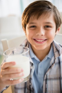 Boy (8-9) drinking milk