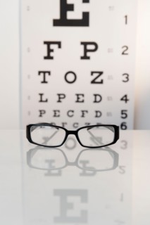 Studio shot of eyeglasses and eye chart