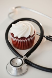Studio shot of stethoscope and cupcake