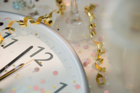 12 o'clock on clock decorated with confetti and streamer
