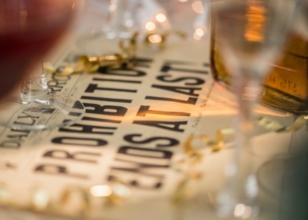 Vintage newspaper on table with alcohol