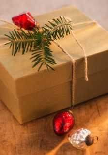 Christmas gift decorated with pine leaf and bauble