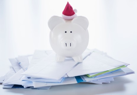 Still life with Santa piggy bank and bills