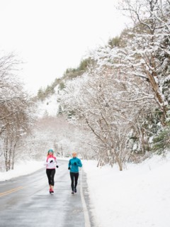 Two women jogging in winter
