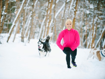 Woman exercising in winter forest