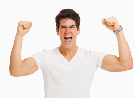 Studio portrait of handsome man cheering and flexing muscles