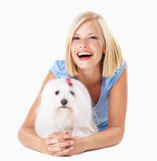Studio Shot, Portrait of smiling young woman lying down with her dog