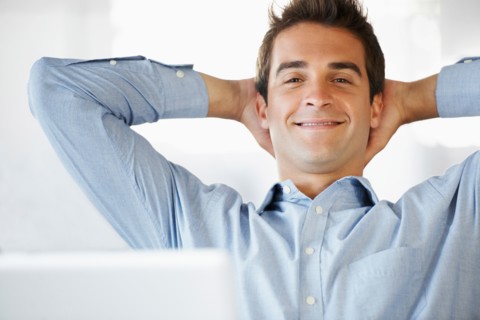 Portrait of man relaxing, hands behind head