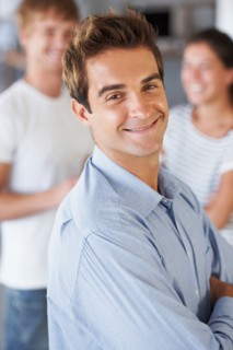 Portrait of man with coworkers in background