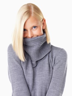 Studio portrait of young woman wearing gray sweater