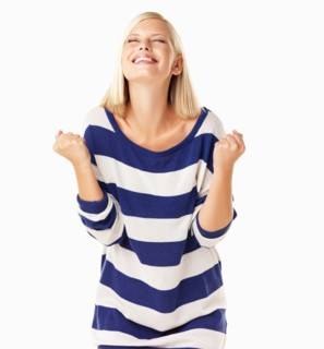 Studio portrait of young woman clenching fists