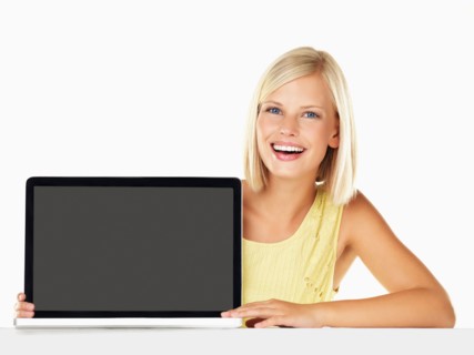Studio portrait of young woman holding new laptop