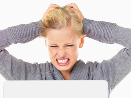 Studio portrait of young woman being frustrated in front of computer