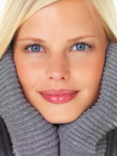 Studio portrait of young woman wearing gray sweater