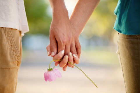 Couple holding hands and flower
