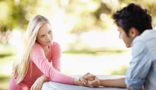 Couple sitting at table outdoors