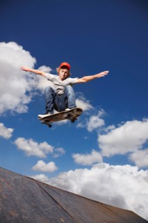Young man on skateboard jumping