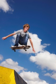 Young man on skateboard jumping