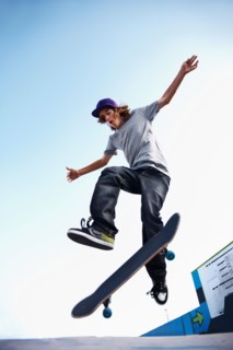Skater performing jump in skateboard park