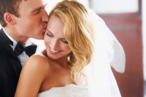 Groom kissing bridge