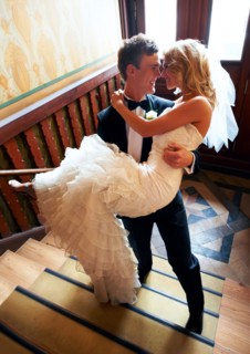 Groom carrying bride