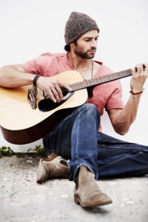 Musician playing guitar outdoors