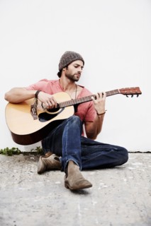 Musician playing guitar outdoors