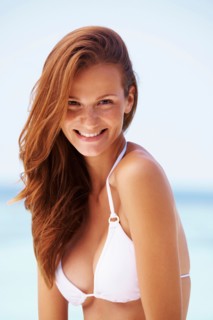 Portrait of smiling young woman in bikini