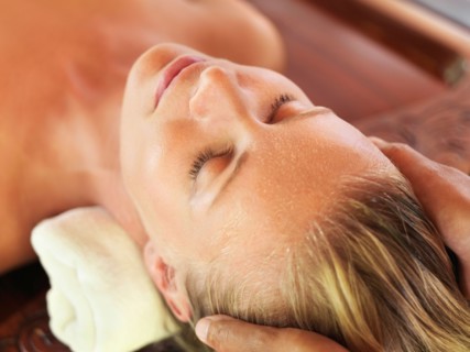 Mid adult woman receiving head massage