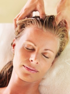 Mid adult woman receiving head massage