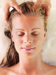 Mid adult woman receiving head massage