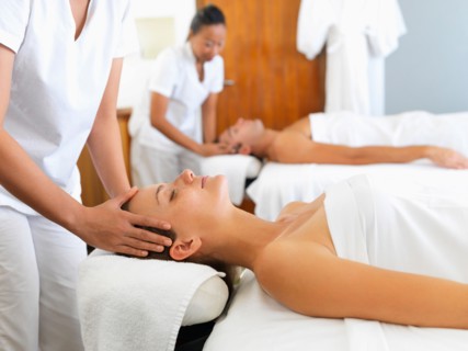 Two people getting massage in spa