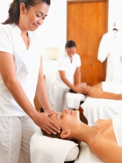 Two people getting massage in spa
