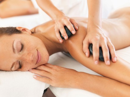 Woman relaxing while getting stone massage