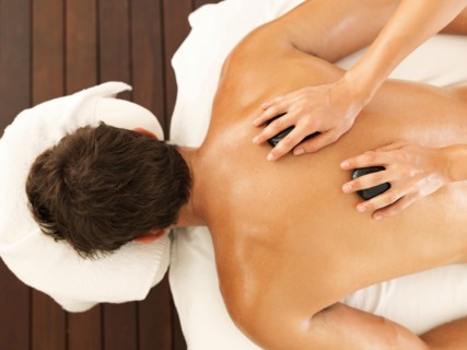Man getting stone massage in spa