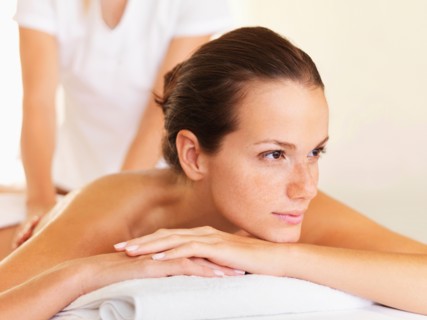 Woman relaxing while getting massage