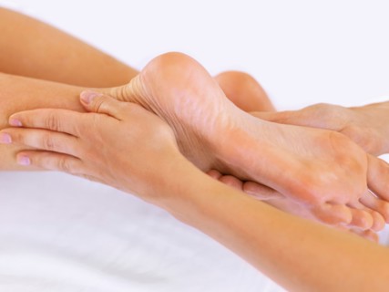 Hand massaging feet