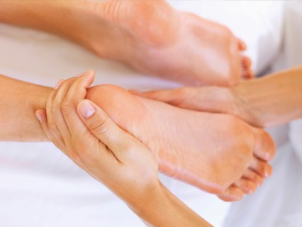 Hand massaging feet
