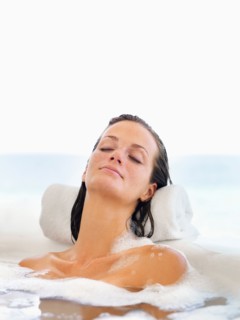 Woman relaxing in bathtub