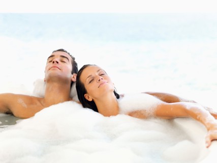 Couple relaxing in bathtub