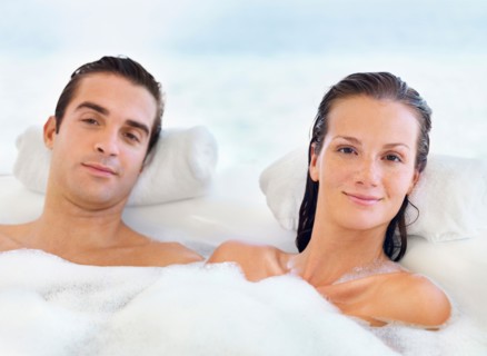 Couple relaxing in bathtub